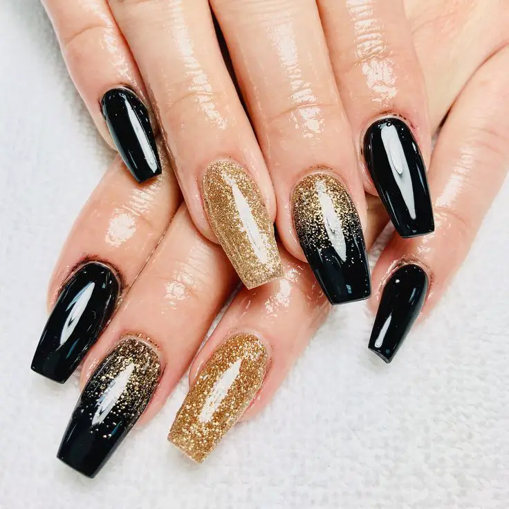 black nails with glitter gold